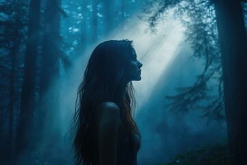 Fototapeta premium Silhouette of a woman with long hair standing in a misty forest, bathed in ethereal light.