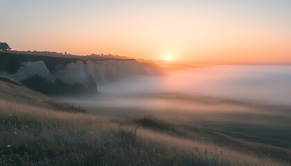 Sunrise over foggy coastal hills