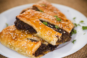 Golden puff pastries with mushroom filling and sesame seeds
