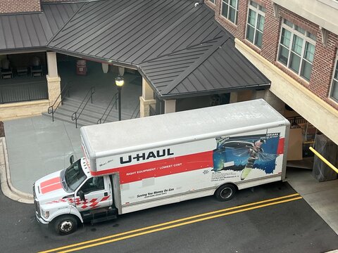U-haul moving truck parked outside of an apartment complex