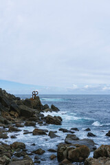 view of cantabria sea with waves on moody day in northern spain