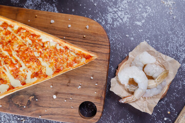 Hot tasty traditional various italian pizzas with salami, meat, cheese, onion, mushroom, tomatoes greens on a dark background