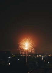 Festive fireworks for the new year over the city. Panorama of the night and evening city with houses.