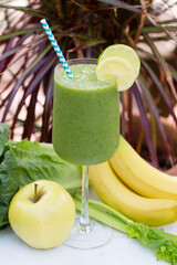 Refreshing green smoothie with lemon, apple, banana, and leafy greens
