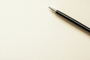Black fountain pen on beige paper background.