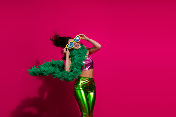 Trendy Young Woman in Colorful Outfit Posing Against Bright Pink Background While Expressing Joyful Emotions During a Celebration