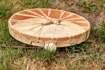 girl playing shamanic drum
