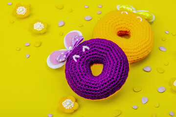 Handmade Easter concept. Crocheted donuts bunnies with traditional decoration. Festive symbols