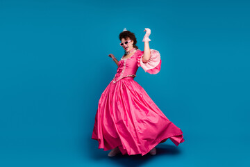 Fototapeta premium Full length photo of happy carefree lady dressed baroque costume dancing copy space isolated blue color background