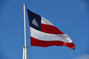 Beautiful flag of the state of Bahia on a sunny summer day with blue sky. Flag of Bahia, Brazil