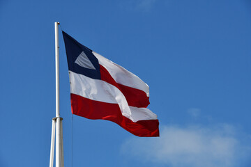 Beautiful flag of the state of Bahia on a sunny summer day with blue sky. Flag of Bahia, Brazil