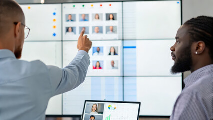 Business & Corporate concept, Collaborative employees discussing data on virtual whiteboard display