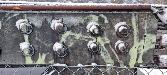 Metal bolts on foot bridge in winter with cold rime closeup