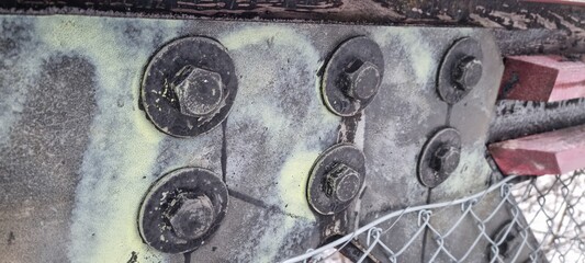 Metal bolts on foot bridge in winter with cold rime closeup