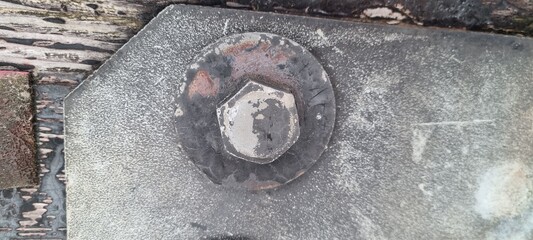 Metal bolts on foot bridge in winter with cold rime closeup