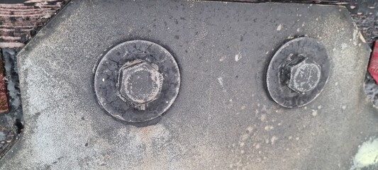 Metal bolts on foot bridge in winter with cold rime closeup