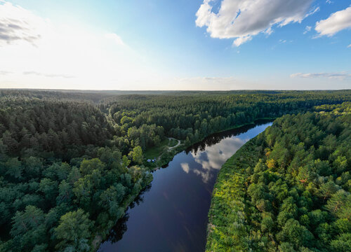 drone photo of the Gauja River in Gauja National Park, taken from a bird's-eye view from above, featuring forest and blue skies in summer, Latvia, Baltic States