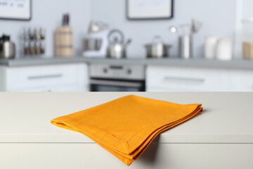 Orange tablecloth on wooden surface in kitchen