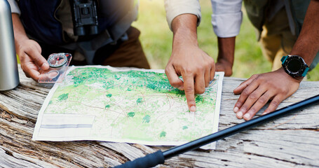 Hands, people and maps with compass for hiking of trekking direction, forest navigation and route....
