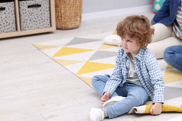 Resentful little boy and his parents at home, space for text. Family dispute