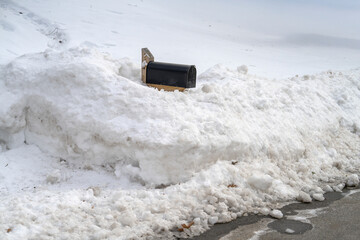 close up on mailbox buried in snow on residential street