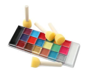 Bright face paint palette and sponges isolated on white