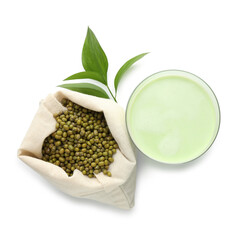 Fresh mung bean juice in glass, seeds and green leaves isolated on white, top view