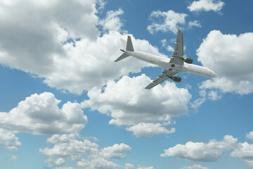 Airplane flying in beautiful blue sky with clouds