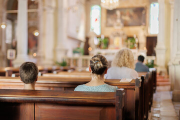 People sitting in a church during a service with natural light illuminating the interior