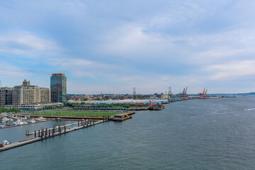 Vibrant harbor shows container ships alongside marina downtown Brooklyn under an overcast sky in NYC America