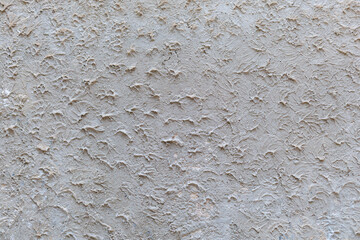 Textured grey wall with intricate patterns resembling natural designs in light and dark shades