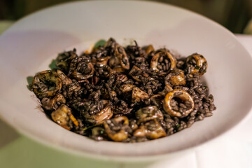 Delicious seafood dish featuring mollusks and black beans served in a local restaurant at night