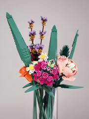 Naklejka premium Prague, Czech republic - February 20, 2025: Colorful lego flower bouquet in glass vase
