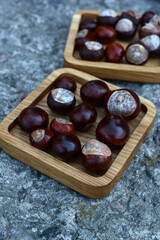many chestnuts are on a wooden board.	
