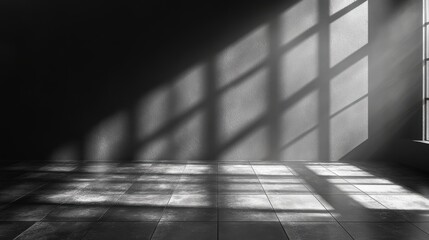 Sunlight casting dramatic shadows across an empty room with a concrete wall and tiled floor