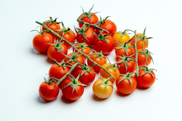 Cluster of Fresh Ripe Cherry Tomatoes on the Vine Against White Background