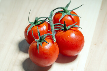 Fresh Vine Tomatoes on a Wooden Surface Captured in Natural Light