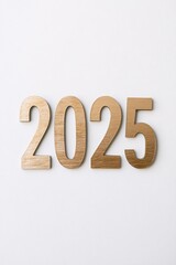 2025 in golden wooden numbers lying on white background