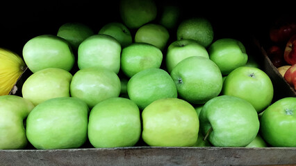 Fresh unripe green apples as background.