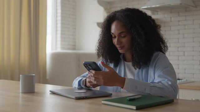 African Curly Woman Sitting In Kitchen, Video Calling, Smiling, Waving Hello