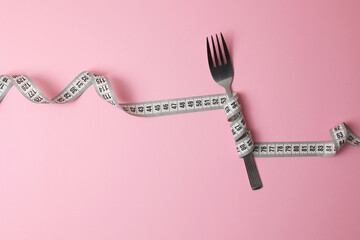 An Artistic Arrangement of a Fork and a Measuring Tape Set Against a Vibrant Background