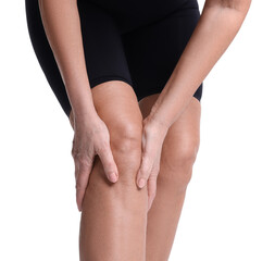 Woman suffering from pain in her knee on white background, closeup