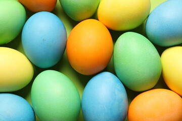 Beautiful decorated Easter eggs on green background, top view
