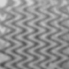 An neutral grayscale abstract wavy grunge texture background.