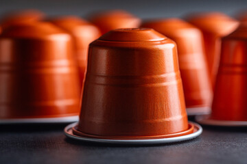 Close-Up of Metallic Coffee Capsule Pods on a Black Background
