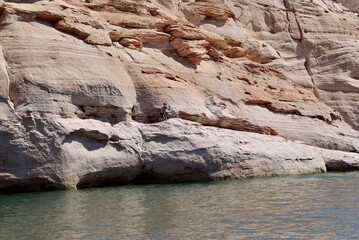 Boy cliff jumping into water, lake Powell