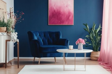 Blue velvet armchair in a modern living room with pink accents.