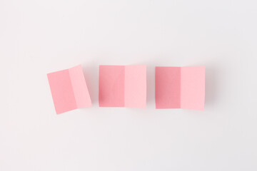 Three pink pieces of paper, each folded in half vertically. Perfect for DIY projects, origami, and...