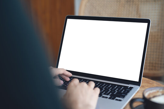 Laptop computer mockup, Woman working on laptop with blank white screen, template for web advertising, online marketing. Business woman searching information on desk at coffee shop.