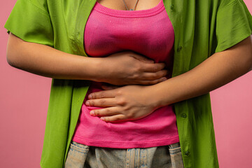 Woman hands squeezing belly with hands. abdominal pain, suffering stomach ache